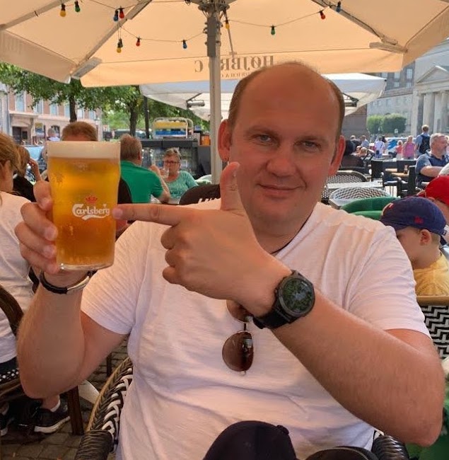 Yaroslav with beer smiling